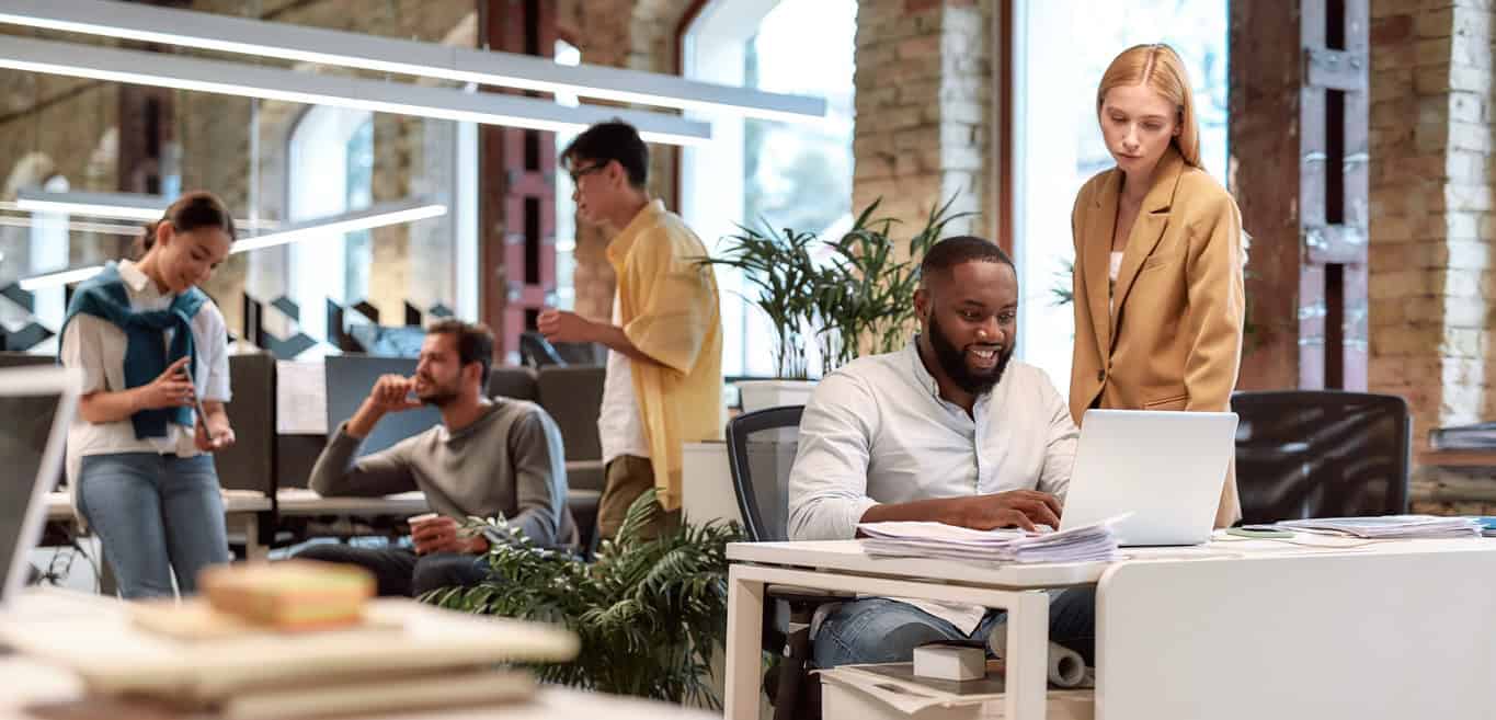 Group of multiracial business people working together in a creative co-working space.
