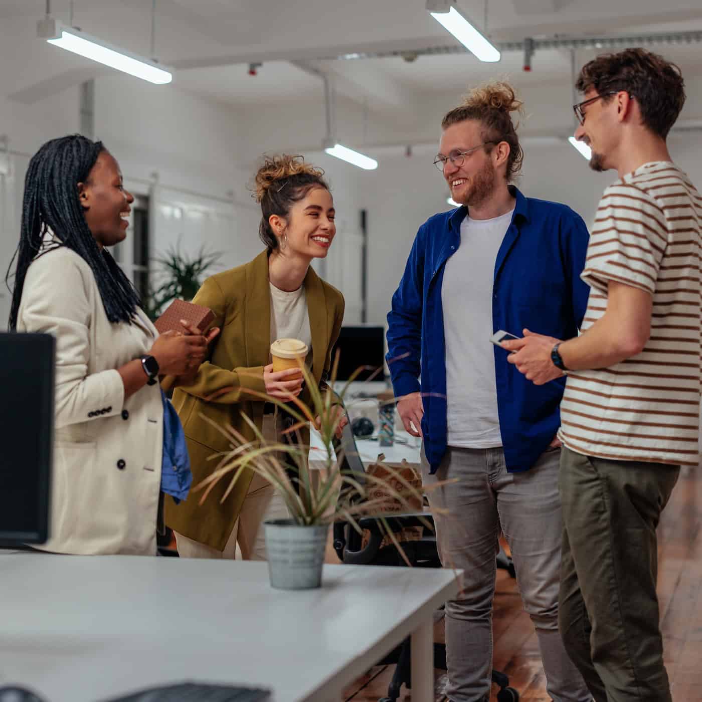 Cheerful multiracial businesspeople having fun in the office during the coffee break